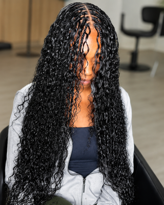 Woman with long wet and wavy boho braids made from Fula Beauty 100% human braiding hair